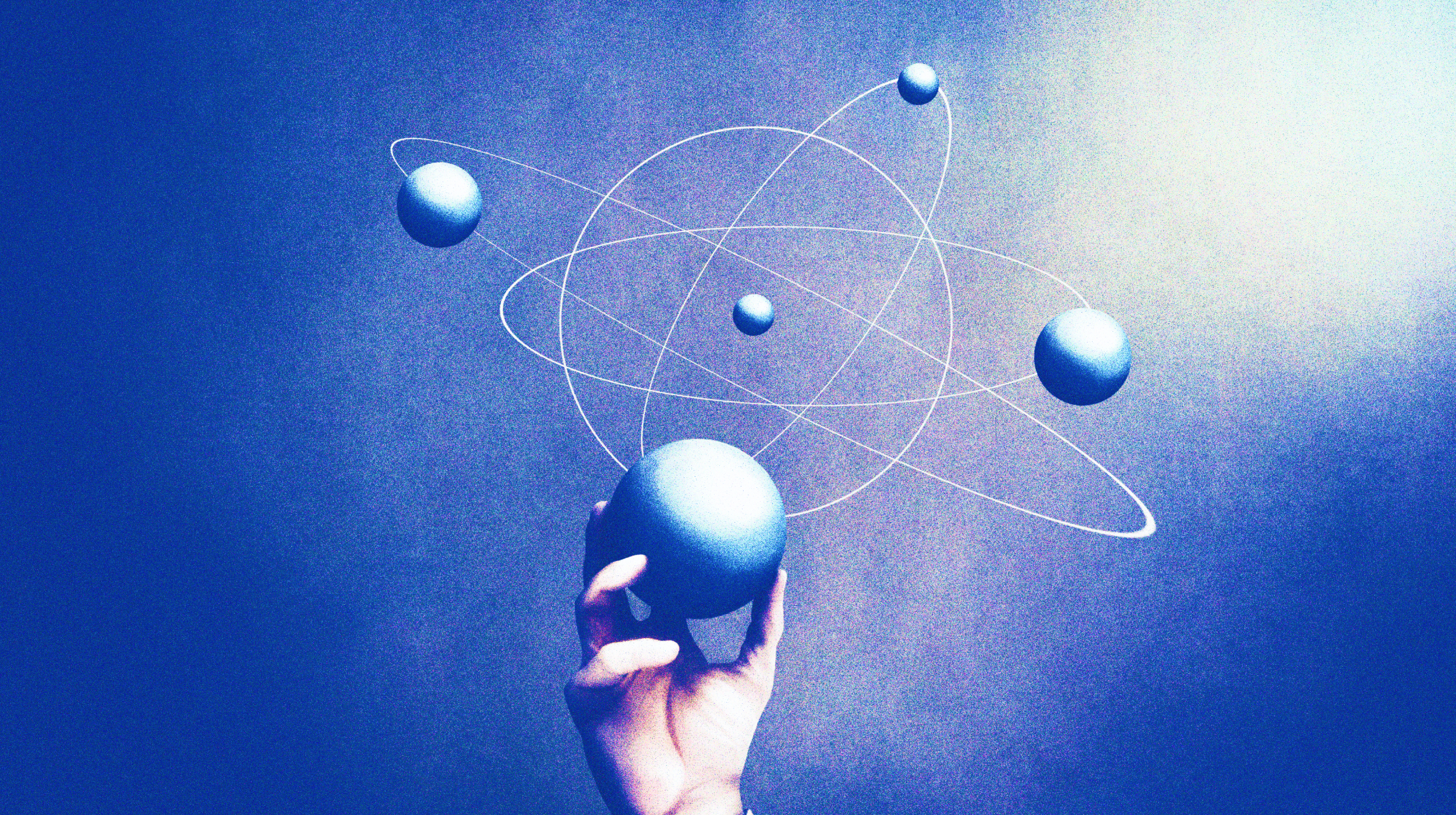 a hand is holding a ball with a model of the solar system.