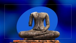 A statue of a buddha sitting on top of a brick wall, with no head.